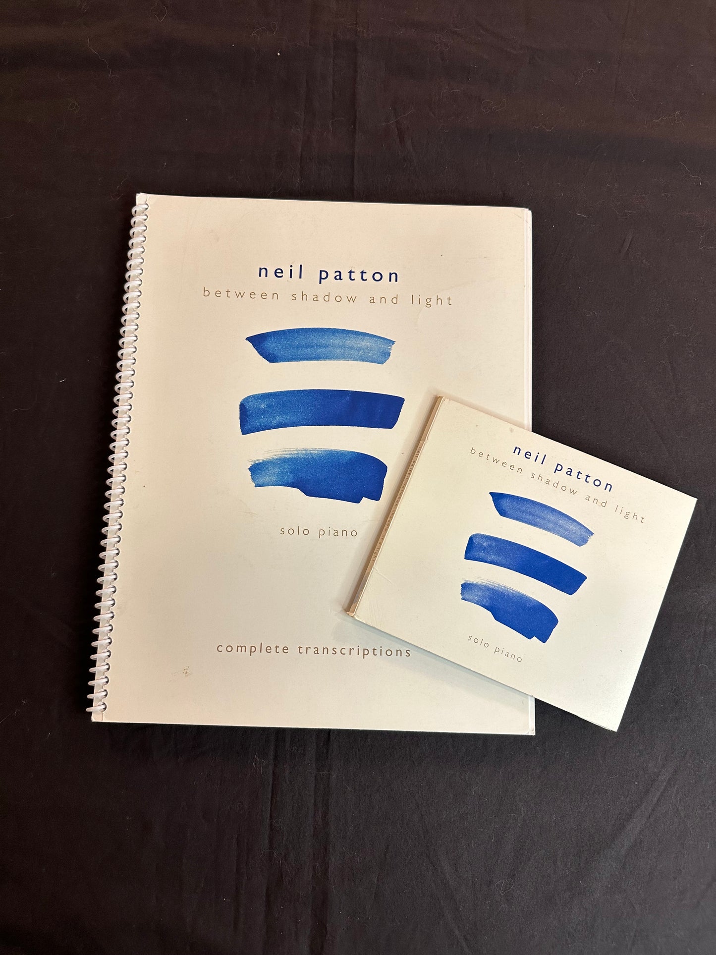 A printed Book and Compact Disc for Neil Patton's Between Shadow and Light album