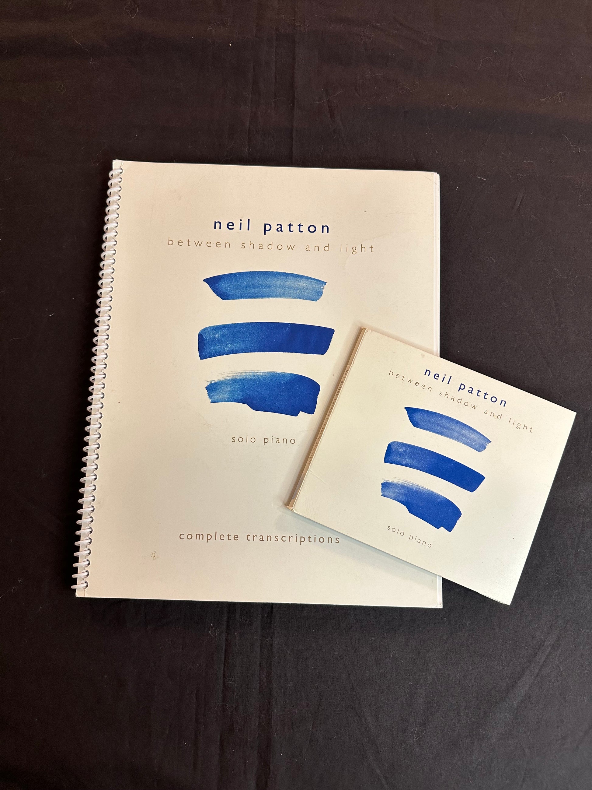 A printed Book and Compact Disc for Neil Patton's Between Shadow and Light album