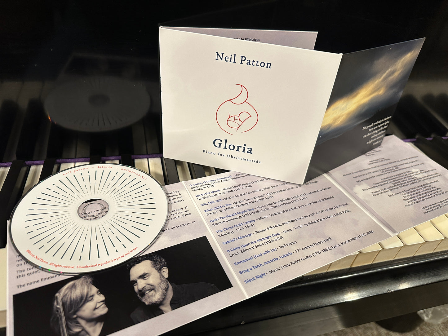 CD and album cover with 'Neil Patton Gloria' on a piano