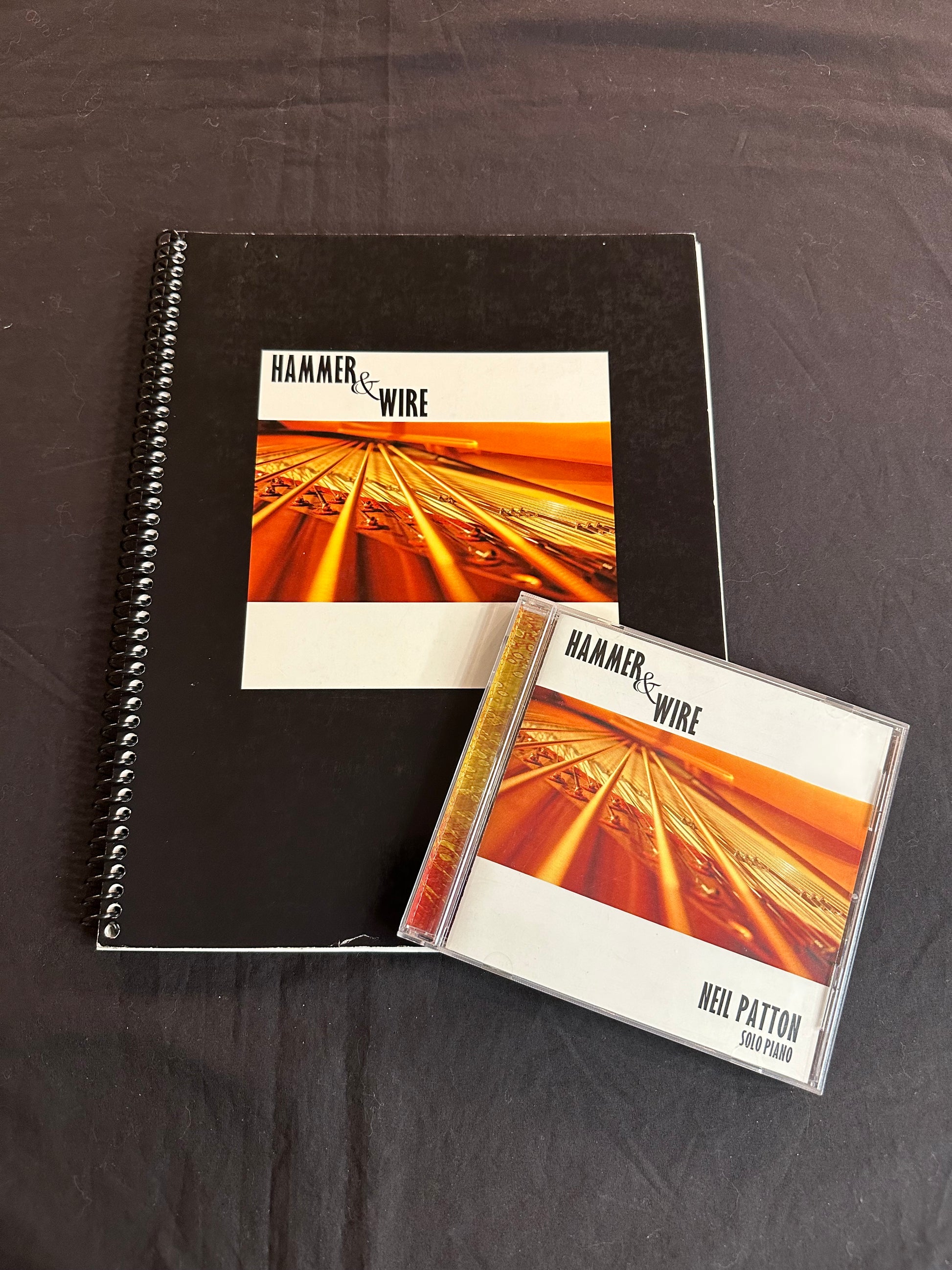 A printed songbook and Compact Disc for Neil Patton's Hammer & Wire album.