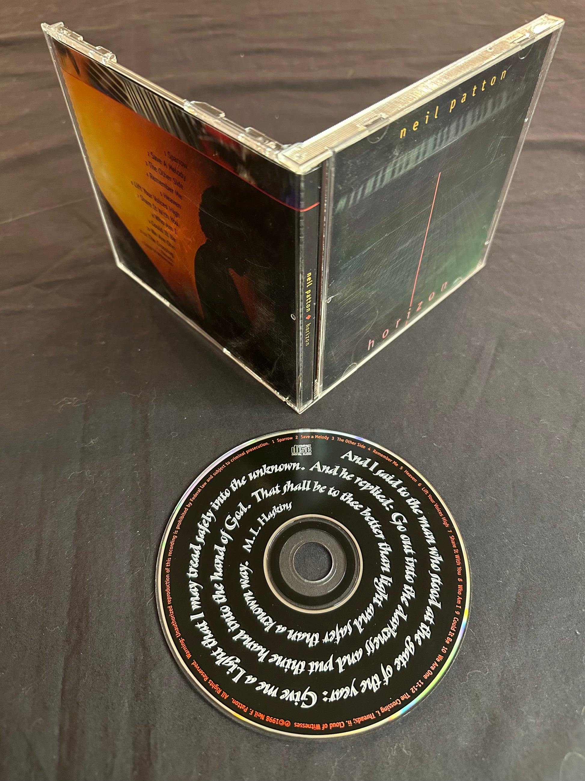 An image of the Horizon CD lying nect to the open jewel case of the album, showing the front and back covers.