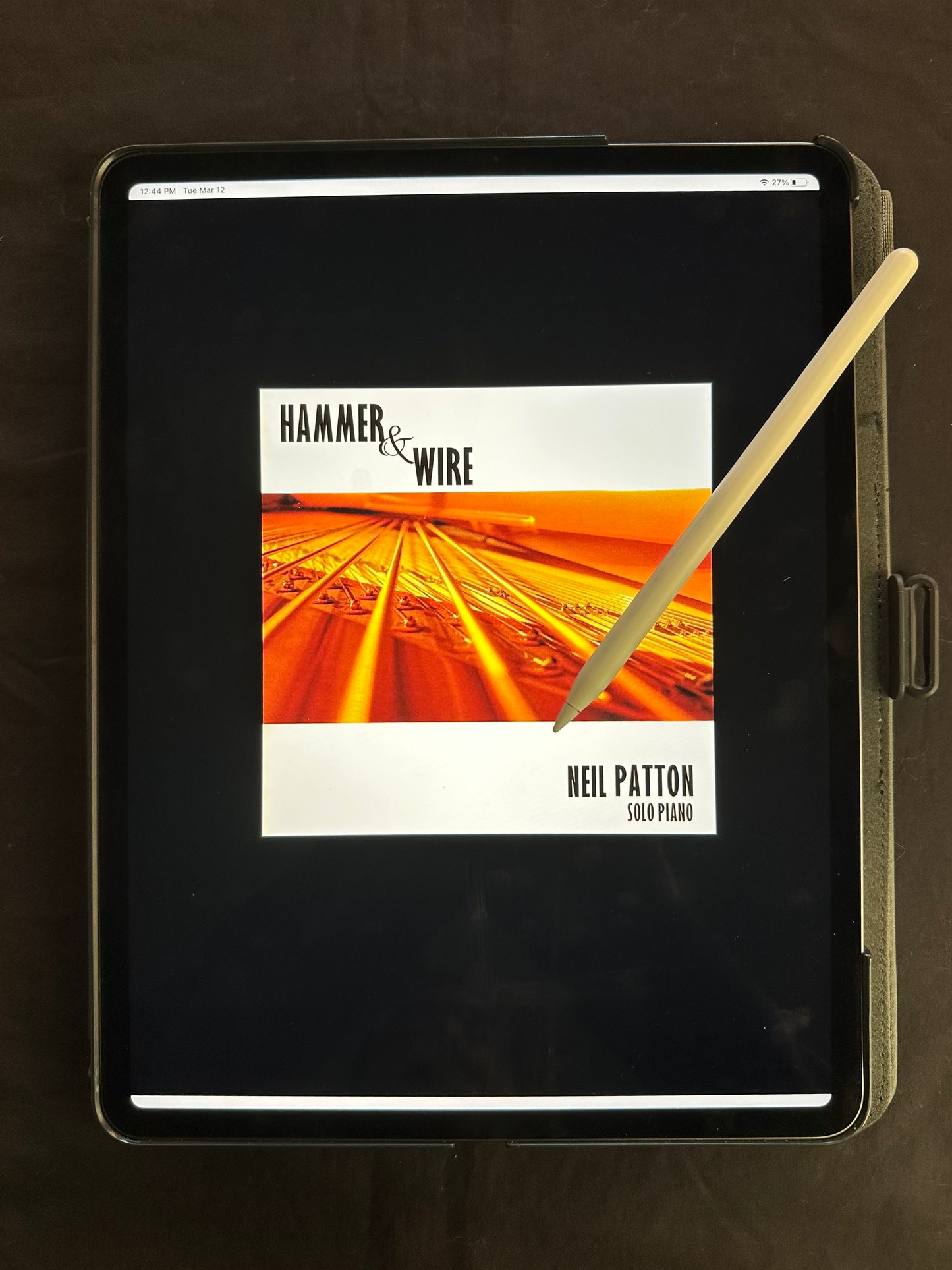 An iPad showing the cover of the Hammer & Wire Digital Songbook.